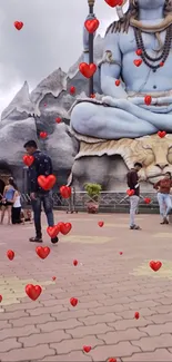 A large Shiva statue with animated red hearts.