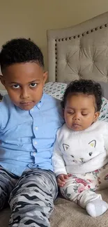 Cute siblings sitting together on a cozy bed.