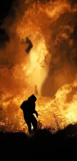 Silhouette against a vibrant, blazing fire display.