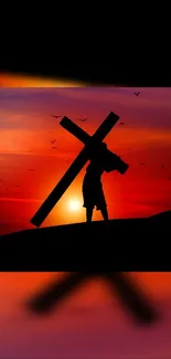 Silhouette carrying a cross against a vibrant sunset.