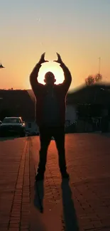 Silhouette of a person against a vibrant sunset, creating a serene and mysterious scene.