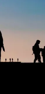 Silhouette of people at sunset on a beach.