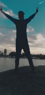 Silhouette of figure by a tranquil evening lake.