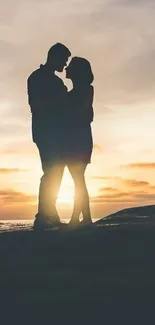 Silhouette of a couple embracing at sunset.