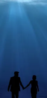 Silhouette of a couple under a blue, serene ocean scene.