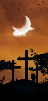 Silhouette of crosses under a crescent moon with vibrant orange sunset background.