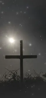 Cross silhouette against a starry night sky wallpaper.