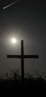 Silhouette of a cross under a night sky with a meteor streaking above.