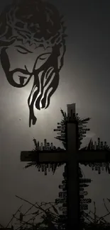 Silhouette of a cross with Jesus' face in dark tones for phone wallpaper.