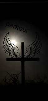 Silhouette of a cross with wings under the moonlight.