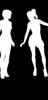 Silhouette figures in dance pose on black background wallpaper.