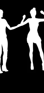 Silhouette of dancing figures on black background wallpaper.