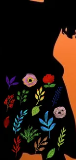 Silhouette with vibrant floral design on orange background.