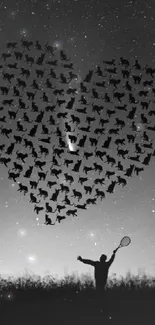 Silhouette of a heart made of birds in the night sky with a person holding a racket.