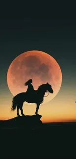 Horse silhouette against a large glowing full moon.