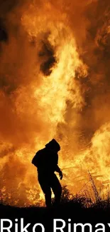 Silhouette standing before a roaring fire, surrounded by vibrant orange flames.