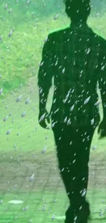 Silhouette walking in the rain with green background.