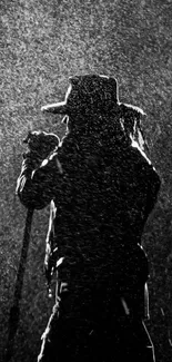 Silhouette of musician in rain at a concert, dramatic black and white theme.