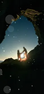 Silhouette of a couple in a rock archway at dusk, starlit night.