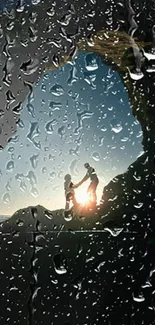 Silhouette of couple in sunset-lit cave, creating a romantic natural scene.