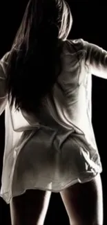 Silhouette of a person in a white shirt.