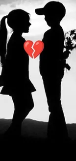 Silhouetted couple with broken heart image.