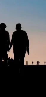 Silhouette of couple at sunset with a beautiful blue and orange sky.