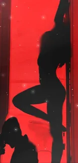 Silhouette art in red light mobile wallpaper.