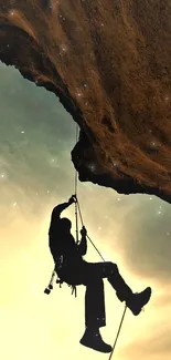 Silhouette of a climber against a dramatic sky at dusk.