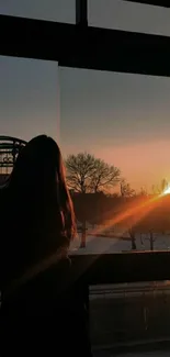 Silhouette against a sunrise through a window, capturing tranquil beauty.