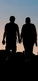 Silhouetted couple walking at sunset on mobile wallpaper.