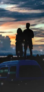 Silhouetted couple on car roof at sunset with vibrant colorful sky.