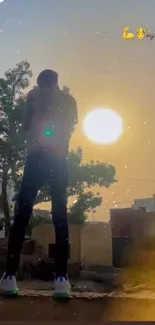 Silhouette of person against sunset on rooftop with golden sky.