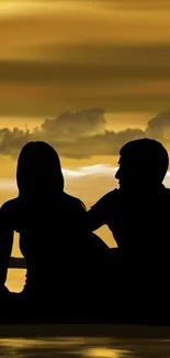 Silhouette of couple against a golden sunset sky in romantic scenery.