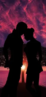 Silhouette of a couple embracing at sunset with a vibrant sky and serene scenery.