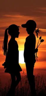 Silhouette of a boy and girl with a sunset background.