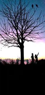 Silhouette of tree and birds at sunset with vibrant sky.