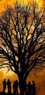 Tree silhouette under a golden moonlit sky.