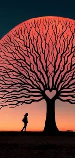 Silhouette of a tree at sunset with heart-shaped pattern.