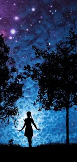 Silhouette beneath a starry cosmic night sky with trees.