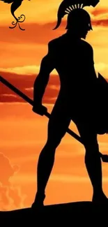 Silhouette of a warrior against a vivid orange sunset.