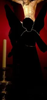 Silhouetted angel with candles on red background.