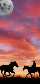 Silhouetted horses at sunset against a vibrant orange sky and full moon.