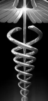 Silver caduceus symbol with wings on a black background.