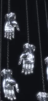 Silver hands hanging in striking design against a black background.