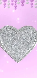 Mobile wallpaper with a silver heart on a pink background.