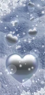 Silver hearts float in a snowy, winter landscape with snowflakes.