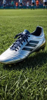 Silver soccer boot on grass field during a match.