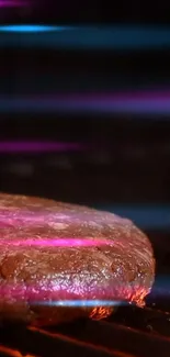 Juicy burger sizzling on a grill with pink and blue lights.