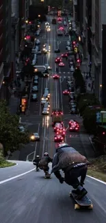 Skateboarders ride downhill in a vibrant city street scene at night.